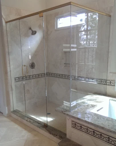 Frameless glass corner shower enclosure