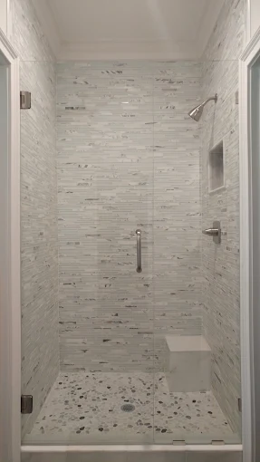 Frameless glass door on a tiled walk-in shower