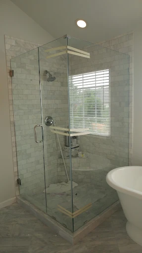 Bright frameless glass shower enclosure