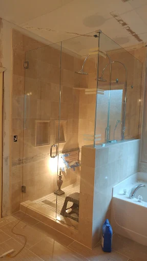 Frameless glass shower enclosure with tile surround