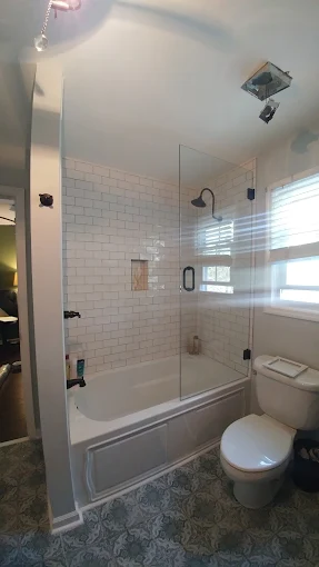 Frameless glass shower in a full bathroom
