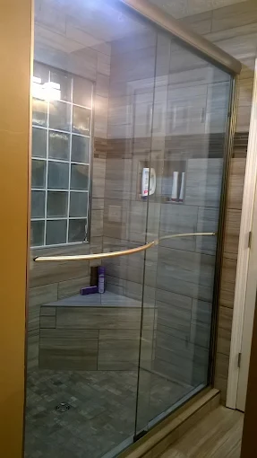 Sliding glass shower door over a tub