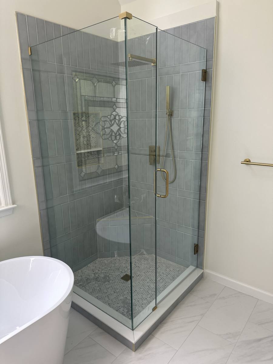 Frameless glass corner shower enclosure installed by Legacy Showers